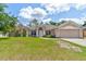 Charming single-story home featuring a well-manicured lawn and a two-car garage at 2951 E Waco Dr, Deltona, FL 32738