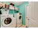 Convenient laundry room equipped with a modern washer and dryer, shelving, and storage space at 2951 E Waco Dr, Deltona, FL 32738