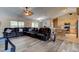 Spacious living room with leather furniture and an open layout into the kitchen at 2951 E Waco Dr, Deltona, FL 32738