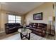 Comfortable living room featuring leather sofas, a glass table, and neutral decor at 2951 E Waco Dr, Deltona, FL 32738