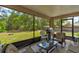 Covered patio with outdoor seating, grill, and a view of the private backyard at 2951 E Waco Dr, Deltona, FL 32738