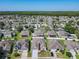 An aerial view of a well maintained neighborhood with mature trees, manicured lawns, and beautiful single-Gathering homes at 2977 White Cedar Cir, Kissimmee, FL 34741