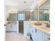 Bright bathroom featuring dual sinks, glass shower and tile flooring at 2977 White Cedar Cir, Kissimmee, FL 34741