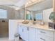 Bright bathroom featuring dual sinks, glass shower and tile flooring at 2977 White Cedar Cir, Kissimmee, FL 34741