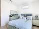 Bedroom with a bed with decorative pillows, a dresser with a mirror, and light-colored walls and tiled floors at 2977 White Cedar Cir, Kissimmee, FL 34741