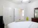 Bright bedroom featuring ceiling fan, double closet and ensuite bathroom access at 2977 White Cedar Cir, Kissimmee, FL 34741