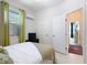 Bright bedroom featuring tile flooring, double closets and ensuite bathroom access at 2977 White Cedar Cir, Kissimmee, FL 34741