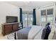 Bright bedroom with a large window providing plenty of natural light and dark curtains at 2977 White Cedar Cir, Kissimmee, FL 34741