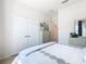 Bright bedroom featuring a closet, dresser with a mirror, and decorative pillows on the bed at 2977 White Cedar Cir, Kissimmee, FL 34741