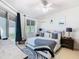 Bright bedroom with a ceiling fan, a large window providing natural light and dark curtains at 2977 White Cedar Cir, Kissimmee, FL 34741