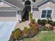 Charming single-story home featuring a two-car garage, brick walkway, and vibrant flower beds at 2977 White Cedar Cir, Kissimmee, FL 34741