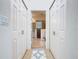 Hallway between closets featuring tile flooring and access to bathroom at 2977 White Cedar Cir, Kissimmee, FL 34741