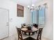Kitchen eat-in featuring decorative lighting, blind-covered window, and adjacent door at 2977 White Cedar Cir, Kissimmee, FL 34741