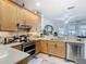 Updated kitchen featuring stainless steel appliances, range hood, and stone countertops at 2977 White Cedar Cir, Kissimmee, FL 34741
