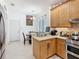 Bright eat-in kitchen featuring updated stainless steel appliances and stone countertops at 2977 White Cedar Cir, Kissimmee, FL 34741