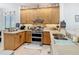 Functional kitchen with ample counter space, stainless steel oven, and wood cabinets at 2977 White Cedar Cir, Kissimmee, FL 34741