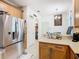 Kitchen featuring stainless steel refrigerator, stone countertops, and large pantry at 2977 White Cedar Cir, Kissimmee, FL 34741