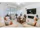 Comfortable living room with a fireplace, ceiling fan, and large windows at 2977 White Cedar Cir, Kissimmee, FL 34741