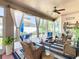 Inviting sunroom with wicker furniture, a ceiling fan, sheer curtains and access to a patio and backyard at 2977 White Cedar Cir, Kissimmee, FL 34741