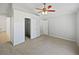Neutral bedroom with carpet, a ceiling fan, closet space, and an attached hallway at 3115 Whispering Trails St, Winter Haven, FL 33884