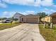 Attractive home featuring a well-maintained exterior, a driveway, and a neatly landscaped front yard at 3115 Whispering Trails St, Winter Haven, FL 33884