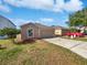 Inviting exterior view showcasing the home's front facade, a well-kept lawn, and a driveway at 3115 Whispering Trails St, Winter Haven, FL 33884