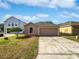 Charming single-Gathering home with a well-manicured lawn and a driveway leading to an attached garage at 3115 Whispering Trails St, Winter Haven, FL 33884