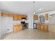 Functional kitchen with wooden cabinets, stainless steel appliances, and tile flooring at 3115 Whispering Trails St, Winter Haven, FL 33884
