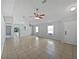 Bright living room with tile floors, a ceiling fan, and lots of natural light from the two windows at 3115 Whispering Trails St, Winter Haven, FL 33884