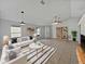 Bright living room with tile flooring, modern white furniture, and charming built-in shelving units at 3115 Whispering Trails St, Winter Haven, FL 33884
