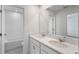 Bright bathroom with double vanity and a bathtub/shower combination tiled to the ceiling at 3532 Douglas Fir Dr, Apopka, FL 32703
