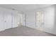 Neutral bedroom featuring a carpeted floor, multiple white doors and a glimpse of the bathroom at 3532 Douglas Fir Dr, Apopka, FL 32703
