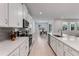 Stylish kitchen featuring white cabinets, stainless steel appliances, a herringbone backsplash, and an island with seating at 3532 Douglas Fir Dr, Apopka, FL 32703