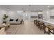 Open-concept living space with modern kitchen island, cozy seating area, and bright natural light at 3532 Douglas Fir Dr, Apopka, FL 32703