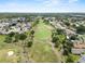 Expansive aerial view of golf course featuring lush greens, winding paths, and surrounding homes at 3660 Ventura Club Cir, Orlando, FL 32822