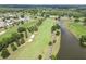 A stunning aerial view of a golf course with a lake and well-manicured greens at 3660 Ventura Club Cir, Orlando, FL 32822