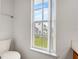 Bright bathroom featuring a toilet and a window offering a view of the outdoors at 3660 Ventura Club Cir, Orlando, FL 32822