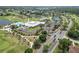 Aerial view of community center with pool, tennis courts, and manicured landscaping at 3660 Ventura Club Cir, Orlando, FL 32822
