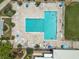 Aerial view of a large community pool area with ample seating, palm trees, and lush landscaping at 3660 Ventura Club Cir, Orlando, FL 32822