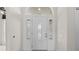 Elegant white front door featuring decorative glass panels and transom window at 3660 Ventura Club Cir, Orlando, FL 32822