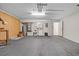 Spacious garage with gray carpeting and pegboard wall includes washer and dryer hookups at 3660 Ventura Club Cir, Orlando, FL 32822