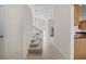 Inviting hallway with tile flooring, staircase, and view of a bright living area at 3660 Ventura Club Cir, Orlando, FL 32822