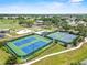 Aerial view of well-maintained tennis courts and playground in a vibrant community at 3660 Ventura Club Cir, Orlando, FL 32822