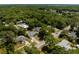 A neighborhood aerial view showcasing homes with mature trees and proximity to roadways at 441 S Blue Lake Ave, Deland, FL 32724