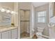Bathroom with an open shower stall, neutral walls, modern lighting, and wood-style floors at 441 S Blue Lake Ave, Deland, FL 32724