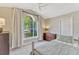 Bedroom featuring an arched window, carpet, light-colored walls, ceiling fan, and standard closet at 441 S Blue Lake Ave, Deland, FL 32724