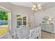 Dining room with a modern table, comfortable chairs, ample natural light, and views of the outdoor area at 441 S Blue Lake Ave, Deland, FL 32724
