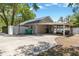 View of the side of the home with a basketball hoop, long driveway, and screened in porch at 441 S Blue Lake Ave, Deland, FL 32724