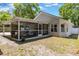 Side view of the home showing the screened in porch, backyard, and the building's structure at 441 S Blue Lake Ave, Deland, FL 32724