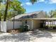 Side view of the home with a basketball hoop, long driveway, and screened in porch at 441 S Blue Lake Ave, Deland, FL 32724